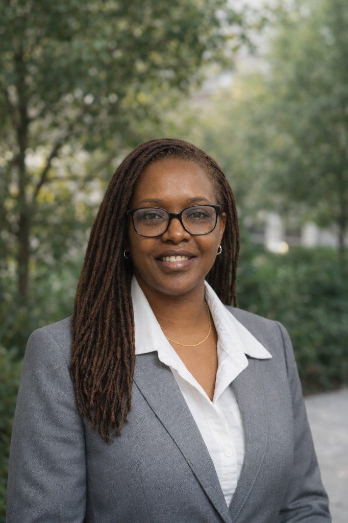 Faith Mwangi, psychiatric mental health nurse practitioner—professional portrait with soft natural greenery in the background, approachable and trustworthy.